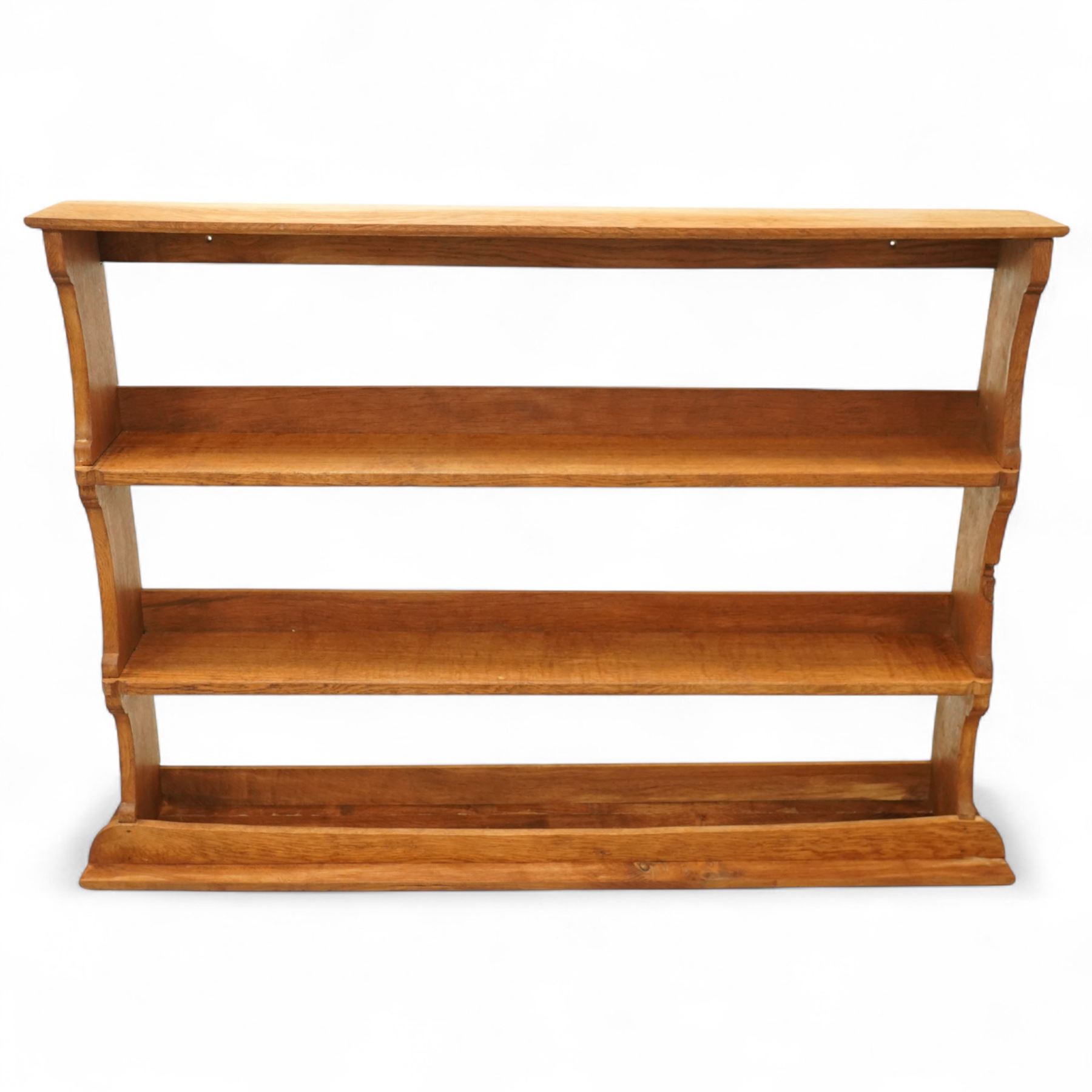 Gnomeman - oak plate rack, rectangular moulded top over three open plate shelves with raised front rails, shaped and chamfered upright supports, stepped base plinth, signature carved Gnome by Thomas Whittaker of Littlebeck