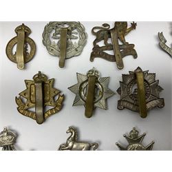 Twenty cap badges including Hertfordshire, Royal Sussex, Cambridgeshire, Hampshire, Notts and Derby, East Surrey, Herefordshire, South Lancashire, Devonshire, Bedfordshire, Durham Light Infantry etc (20)