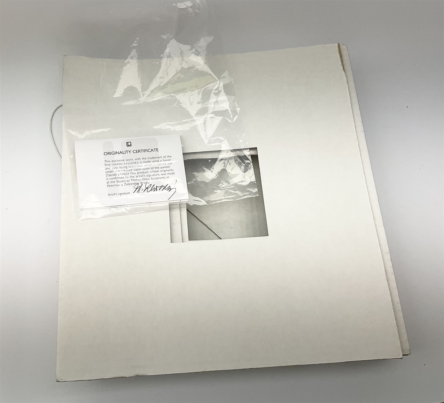 Zdenek Lhotsky glass platter, decorated with geometric motifs in pink and blue upon a white ground, L26cm, with certificate and box.