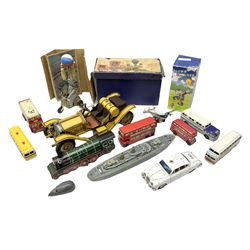 Fourteen modern tin-plate toys, predominantly continental/Eastern, including Clown Drummer and battery operated locomotive; both boxed; six buses; battleship; aircraft; elephant juggling ball; police car; etc; together with a tin-plate model of a vintage car (15)