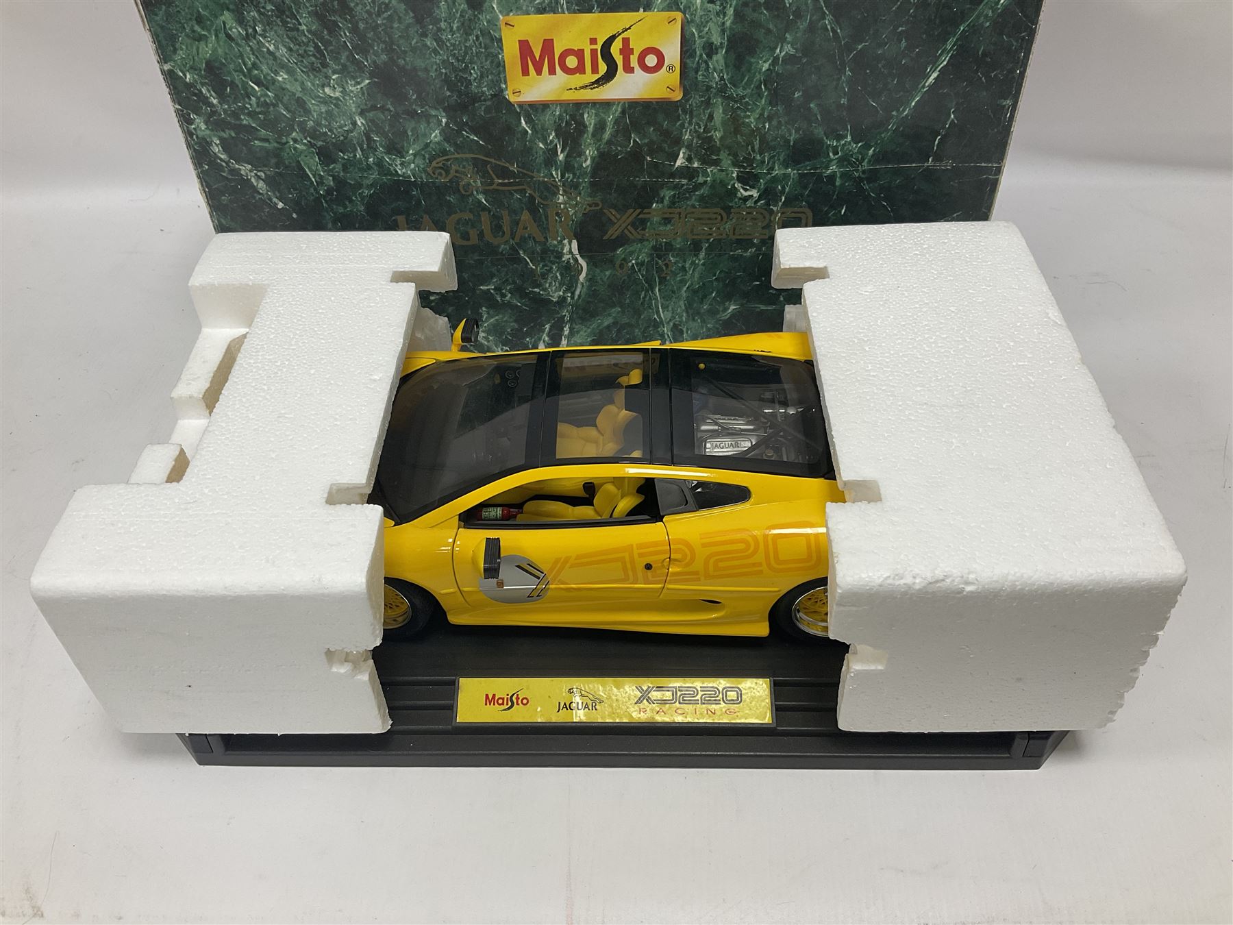 Two Maisto 1:12 scale Jaguar XJ220 ‘Racing’ cars in yellow, both on plinths in original boxes 