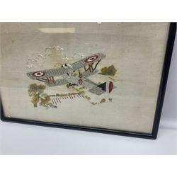 WW1 French embroidered silk picture of a British bi-plane in flight over fields firing its gun 25 x 37.5cm; ebonised frame