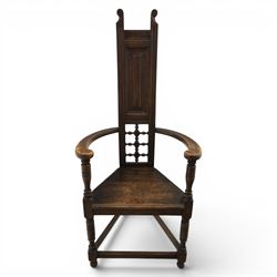 Manner of Liberty & Co. - Arts & Crafts oak Shakespeare chair, high back over triangular seat, flanked by swept arms, raised on turned and block supports united by stretchers
