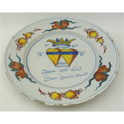  Mid 18th century Delft marriage plate decorated with polychrome enamels, with stylized stylised floral designs, entwined hearts and and motto, D35cm   