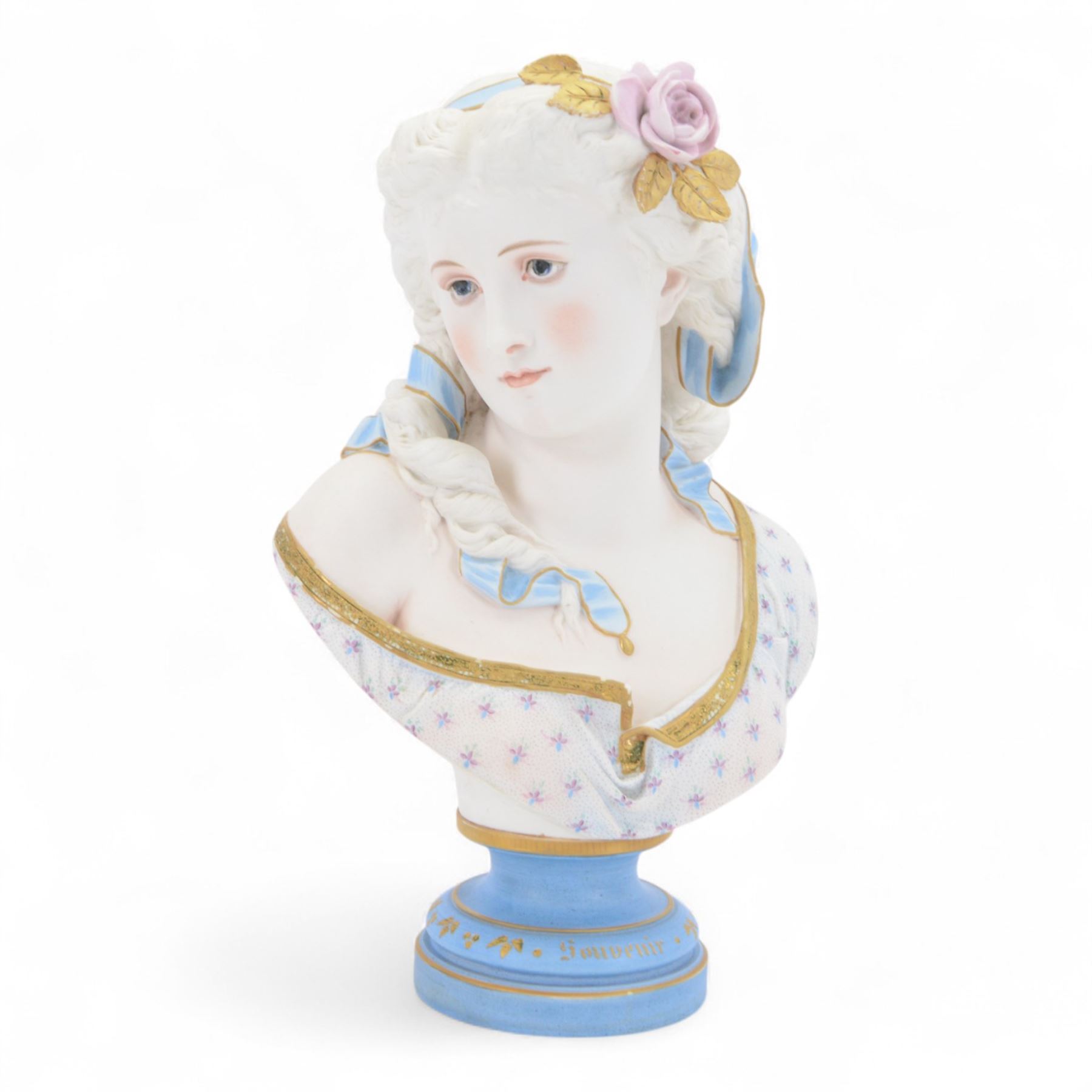 Late 19th century French Limoges bisque porcelain bust, by Henri Ardant, modelled as a young maiden with ribbon and rose in her hair, after A. Carrier, upon a blue socle base entitled 'Souvenir' in gilt, marked beneath, H37cm

