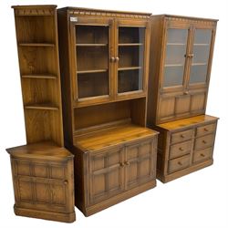 Ercol - mid-20th century dark elm 'Old Colonial' three sectional wall display unit, comprising two units and corner unit, fitted with open shelves, glazed cupboards and drawers