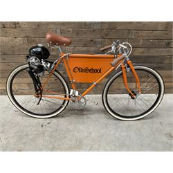 Fully restored vintage advertising bicycle with 2 stroke petrol engine, orange frame, tan leather seat