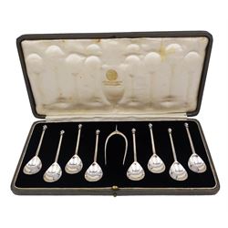 Set of eight 1930s silver coffee spoons, with fluted ball finials, and a pair of silver wishbone sugar nips, hallmarked Thomas Bradbury & Sons Ltd, Sheffield 1936, in fitted case with velvet and silk lined interior