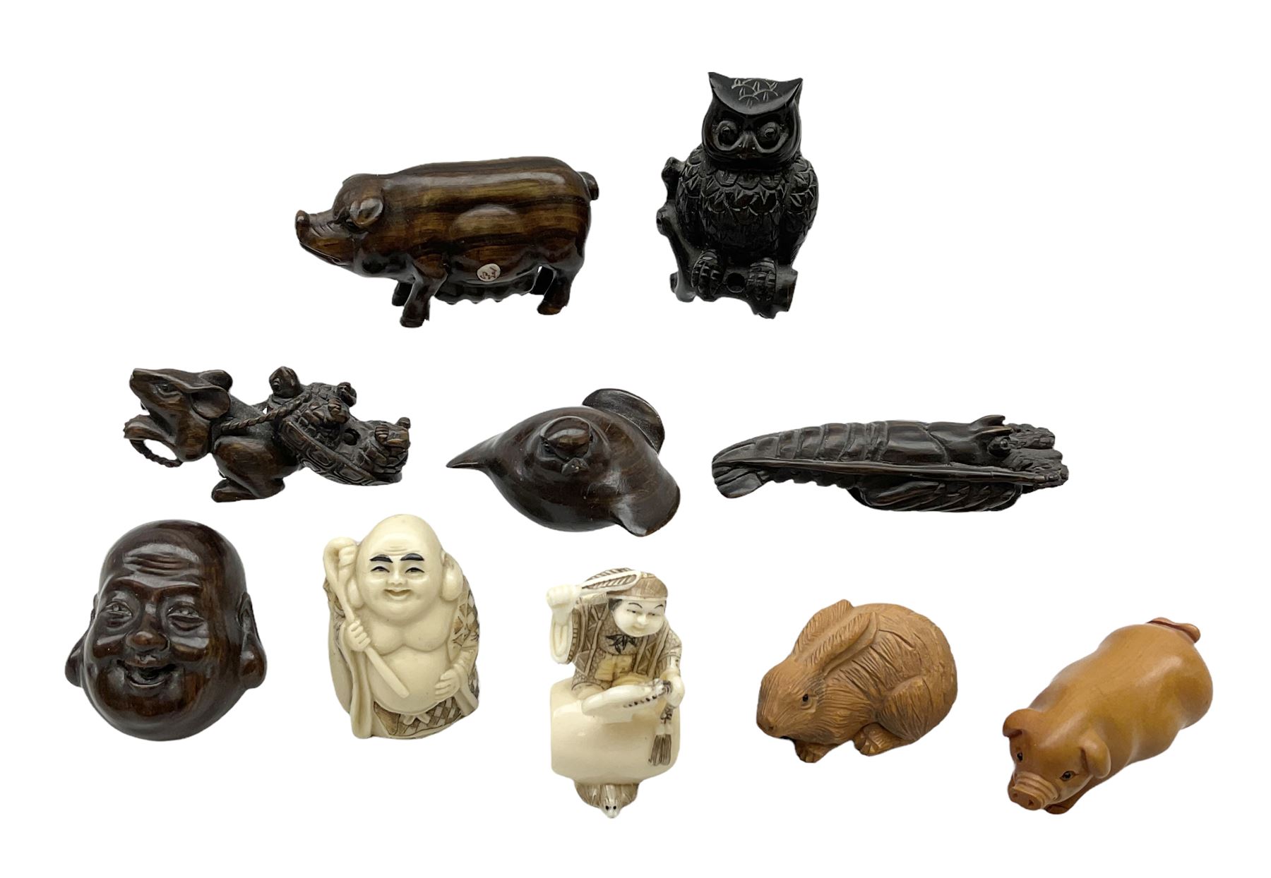 Group of ten Japanese netsukes, comprising eight carved wooden examples, and two ivorine examples, of various form, examples modelled as pigs, owl, mouse with tortoise upon its back, birds, rabbit, etc. 