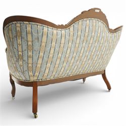 Victorian mahogany double cameo back sofa, the shaped back with central button upholstered oval panel and carved foliate crest above upholstered arms and seat, raised on cabriole legs terminating in castors
