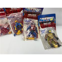 Thirty-one Masters of the Universe He-Man figures re-bagged on original backing cards;  two others lacking backing cards; boxed Modulok figure; bag of weapons and accessories; Roton, two horses and two battle cats; 1986 & 1987 Annuals; Ladybird and other story books; Panini sticker album; instructions etc