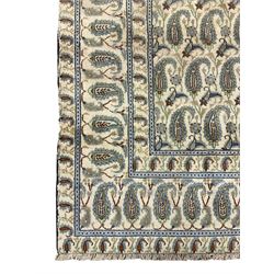 Central Persian Kashan ivory ground carpet, decorated with repeating Boteh motifs, the three band border decorated with further Boteh motifs