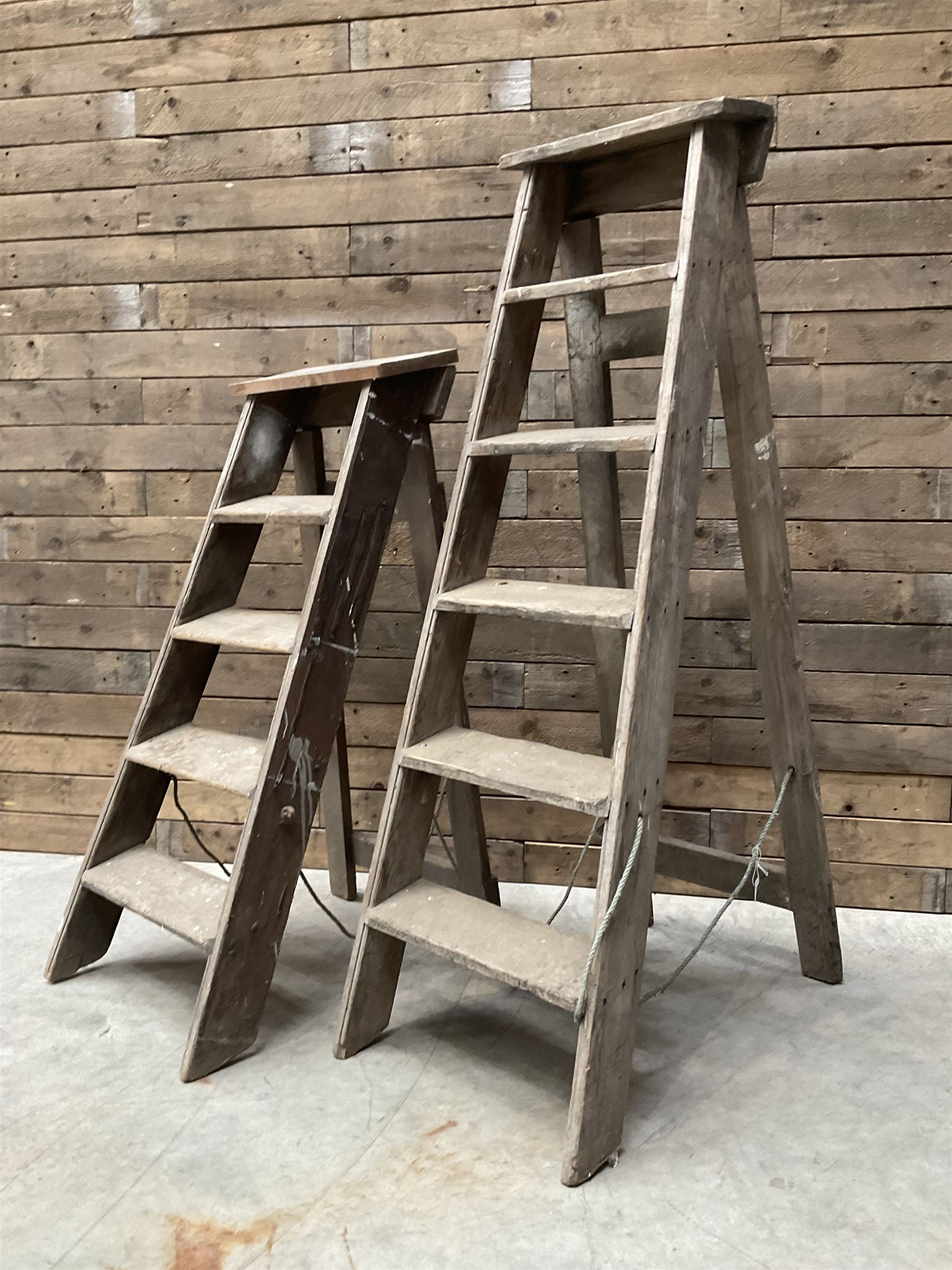 Two antique wooden step ladders, H100cm and 140cm