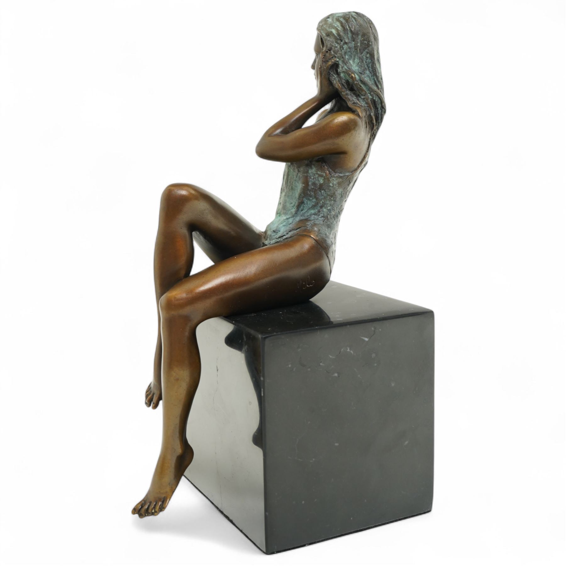 Bronze modelled as a seated lady, signed Milo, on black hardstone base, H25cm 