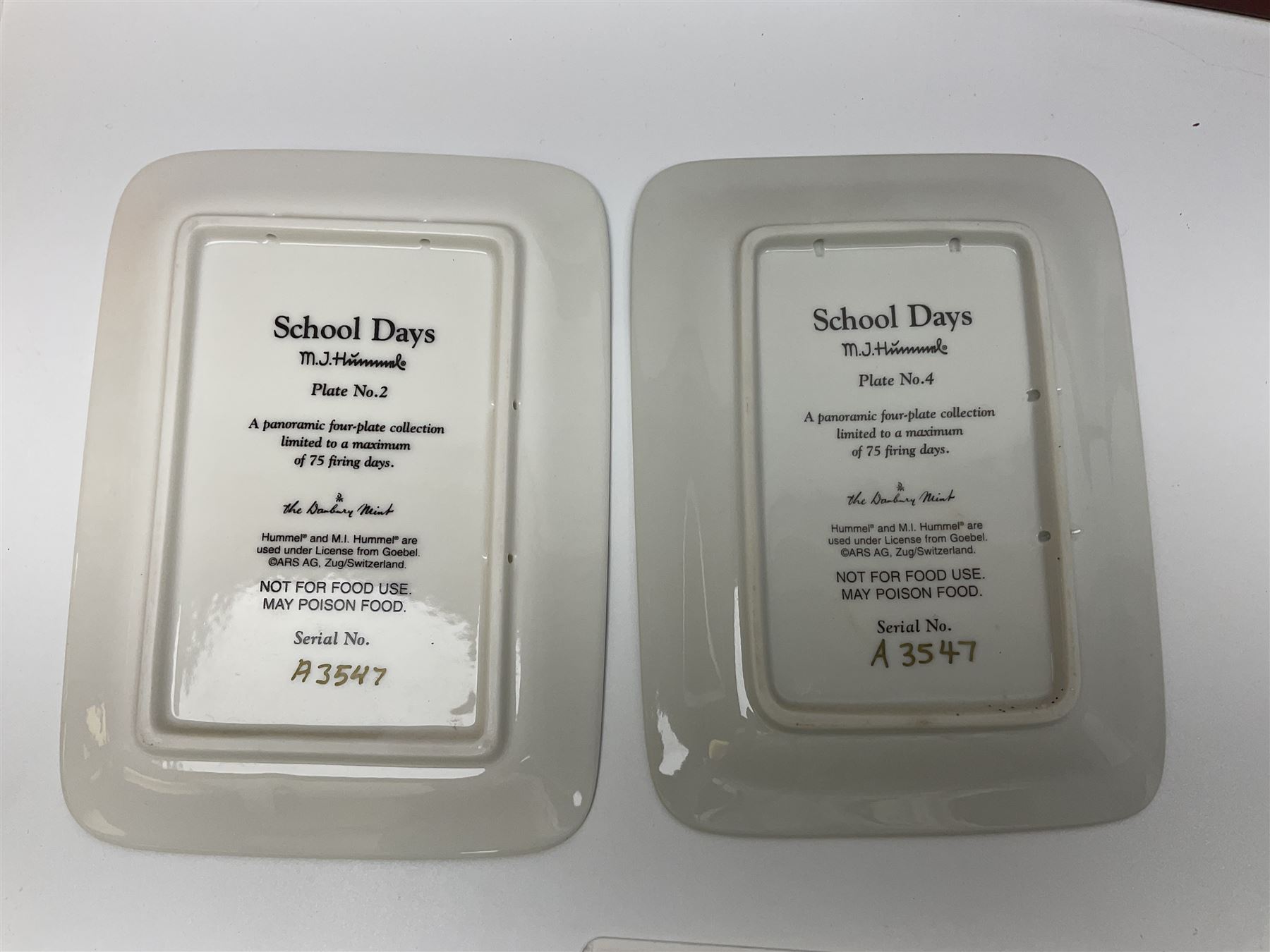 Two ceramic Hummel postcards by Goebel, both displayed on wooden easels, together nine Hummel eggs, set of four Hummel School Days plates, on wooden hanging rack, Goebel Collectors Club Member plaque etc