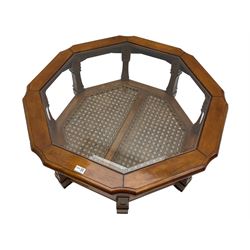 Octagonal coffee table with glass inset, square supports joined by cane undertier