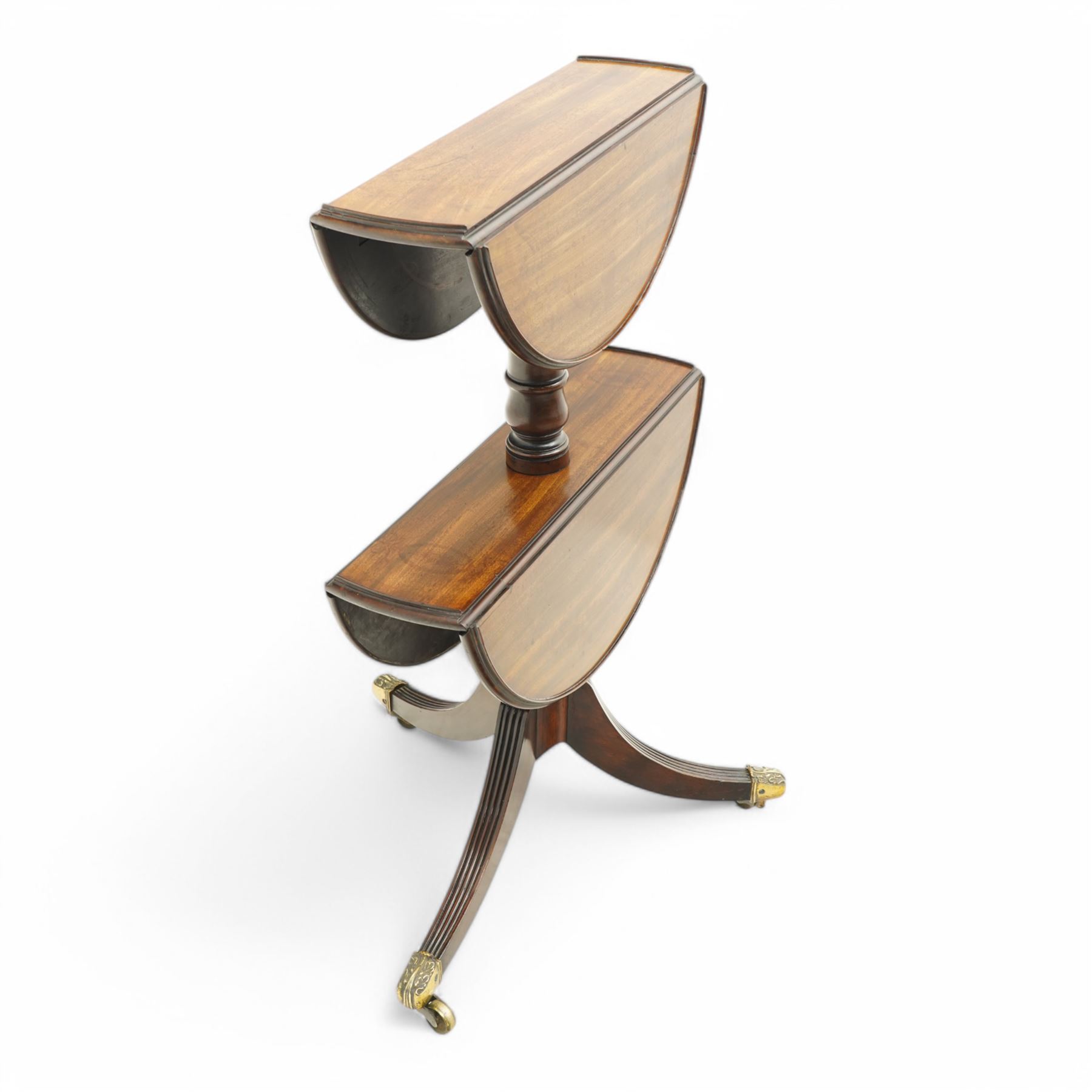 George III mahogany dumb waiter, two graduating drop-leaf tiers with moulded edges and raised lip surrounds, fitted with hinged stays, on turned columns and tripod base, three reeded out-splayed supports with ornate cast brass cups and castors, diameter 53& 59cm 
