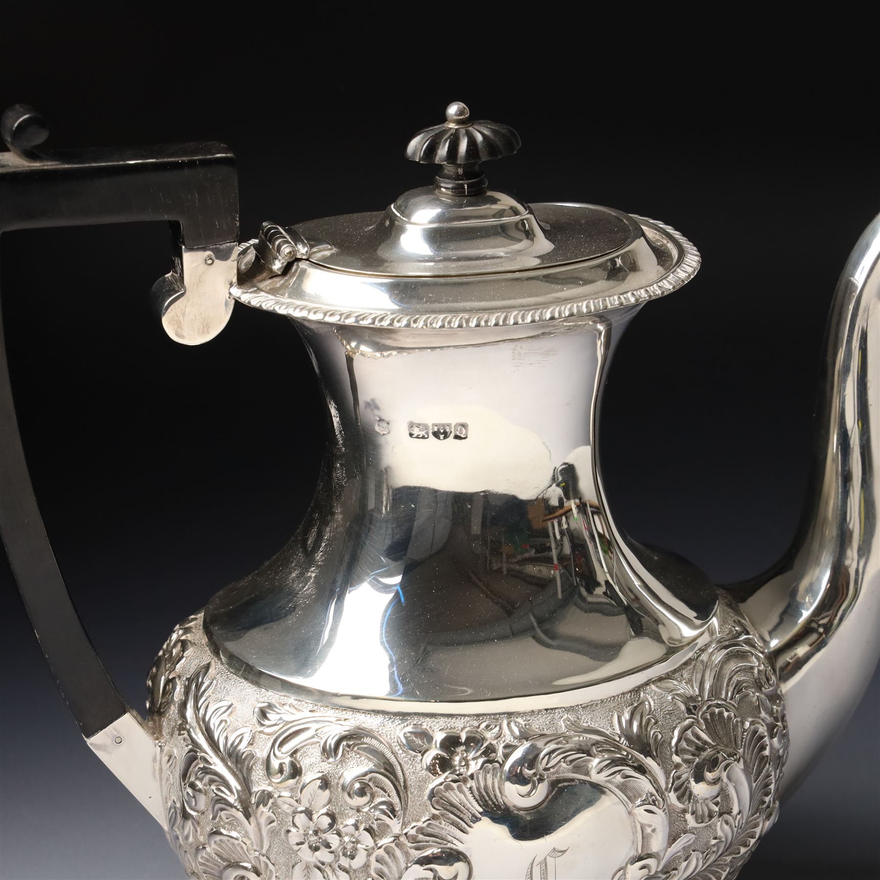 Late Victorian four piece silver tea set comprising teapot, coffee pot, sugar bowl and milk jug with embossed decoration, the cartouches engraved with an initial, the teapot and coffee pot Chester 1899 Maker George Nathan & Ridley Hayes, the sugar bowl and milk jug Birmingham 1899 Maker Thomas Hayes