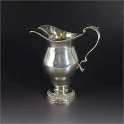 Modern three piece silver tea service, comprising coffee pot, teapot and milk jug, each of spherical form, upon circular domed foot, the teapot and coffee pot with wooden handles, the teapot with wooden finial, hallmarked Bryan Savage, London 1975, coffee pot H29cm