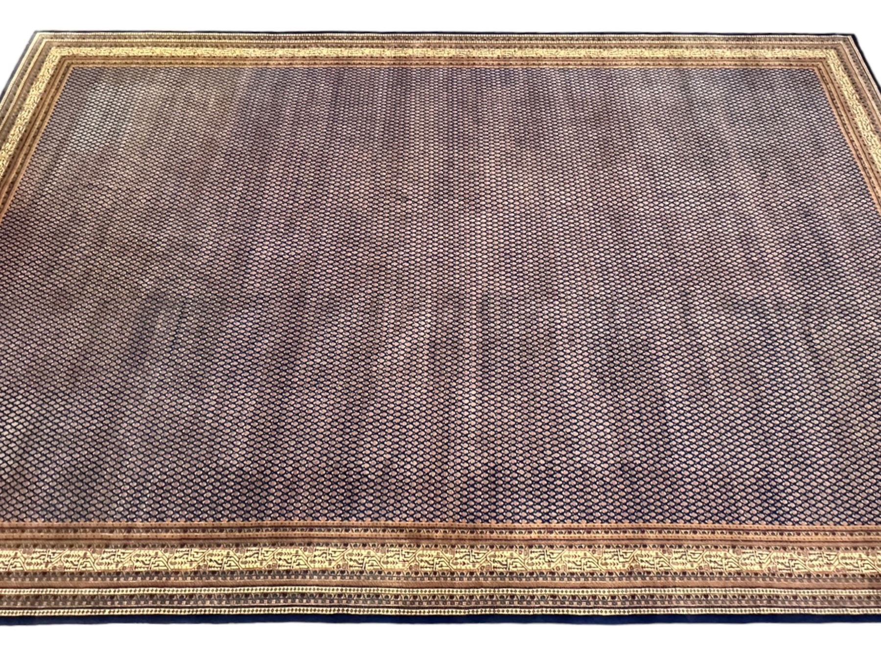 Large North-West Persian Arrak indigo ground carpet, the field decorated all-over with small Boteh motifs, multiple band border decorated with repeating geometric designs 