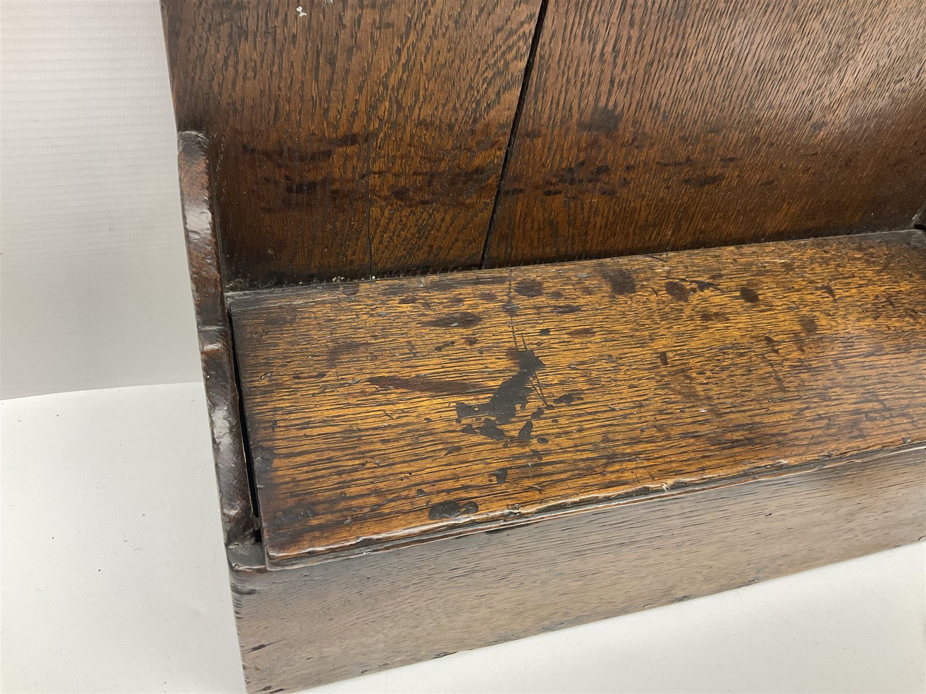 George III oak spoon rack and candle box, the rectangular backplate with shaped  pediment and two six aperture spoon racks, above a candlebox with hinged cover, with various brass spoons and a pair of brass candle snuffers, H56.5cm, W35cm, D14cm 