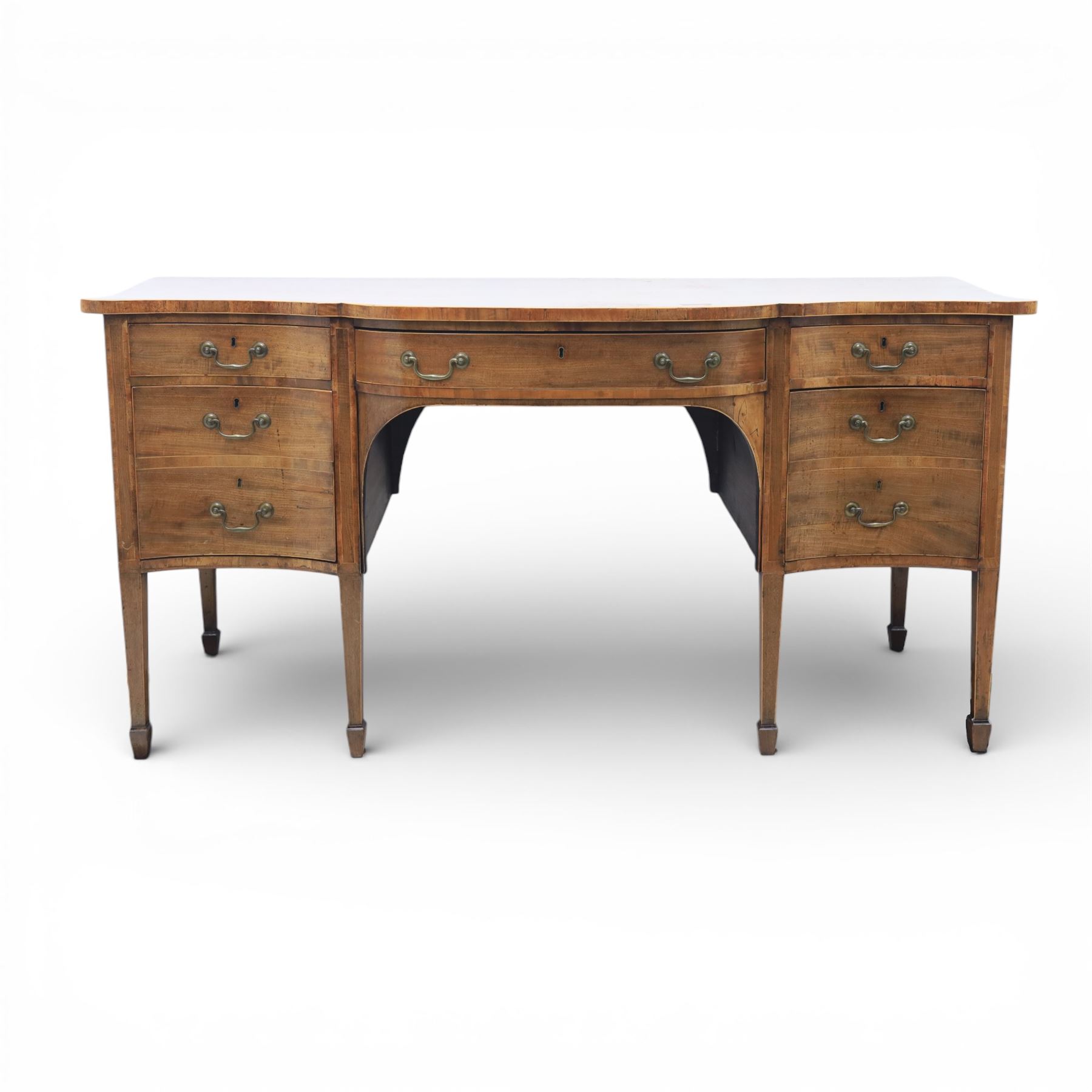 Early 20th century mahogany bow front sideboard, the shaped and moulded top above central kneehole recess with baize lined frieze drawer, flanked by twos drawers either side with the lower drawer double height, raised upon square tapering legs with spade feet