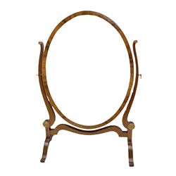 Georgian style oval dressing table mirror, the bevelled plate within an oval frame with walnut veneer  with concentric circle design and upon two bracket feet, H57cm