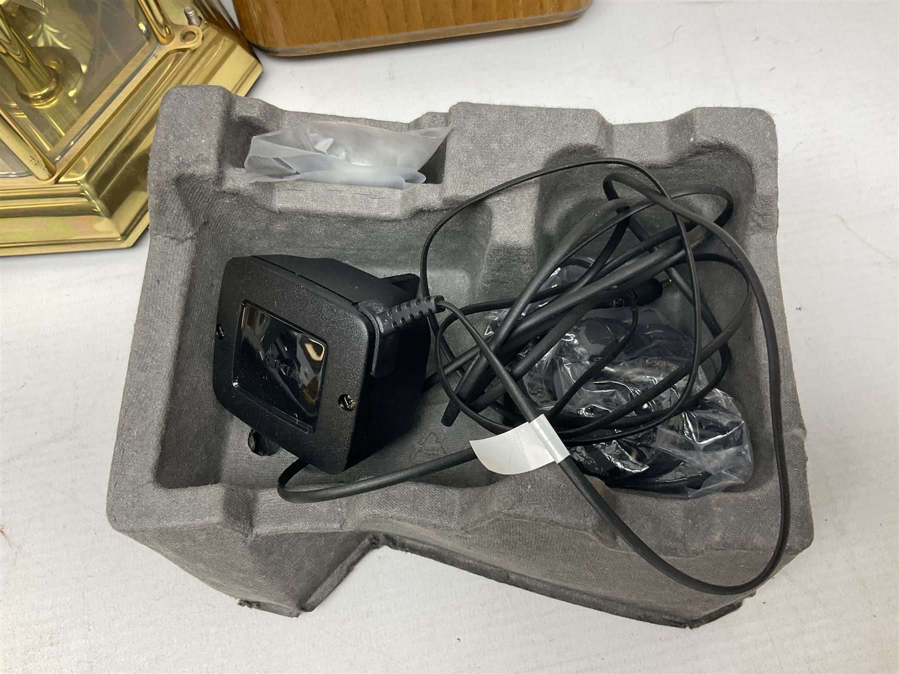 Kundo quartz clock, miniature brass clocks, two barometers, Sony digital camera, Nokia phone, Monarch Remington typewriter, commemorative Shilling etc