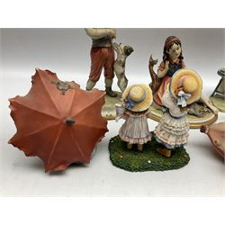 Four Capodimonte figures comprising example modelled as a girl reading with a puppy, boy giving a bone to a dog, boy reading on cushion and tramp boy sat cross legged with umbrella, together with three The Leonardo Collection figures comprising Midsummer Melody, Alfresco and Butterfly Catchers