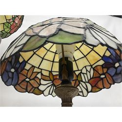Tiffany style lamp in the form of a semi nude woman holding up a leaded lampshade together with a similar table lamp