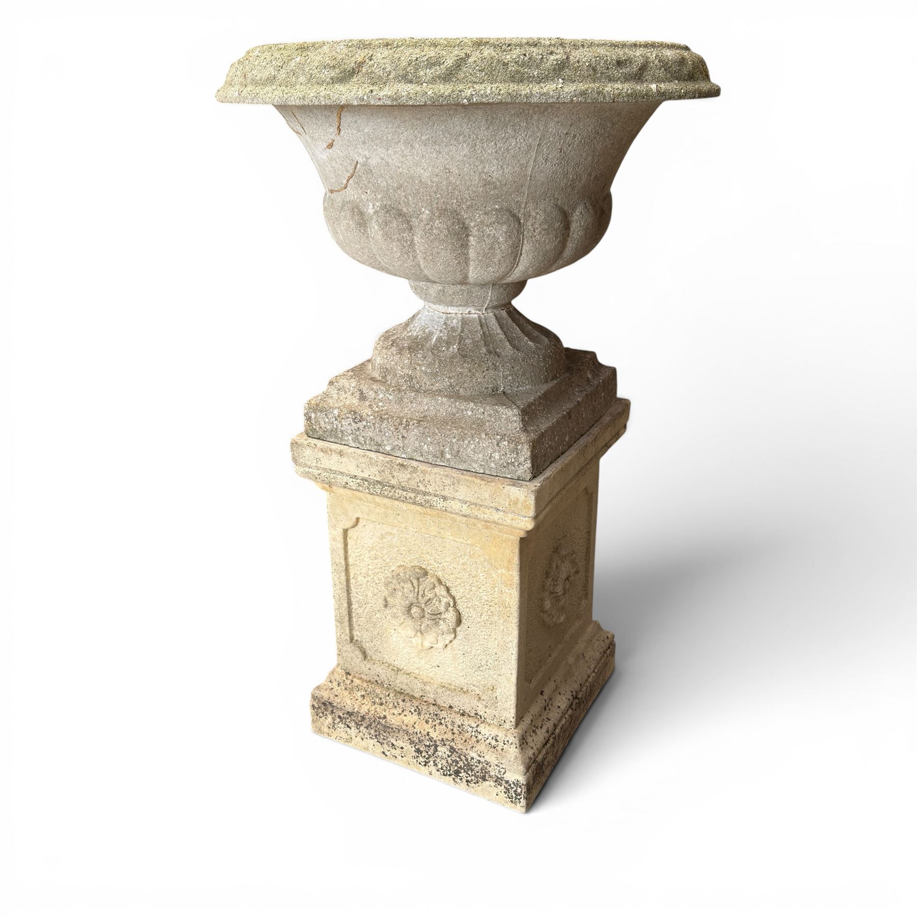 Weathered cast stone statue of a child and urn planter on pedestal along with three piece bird bath