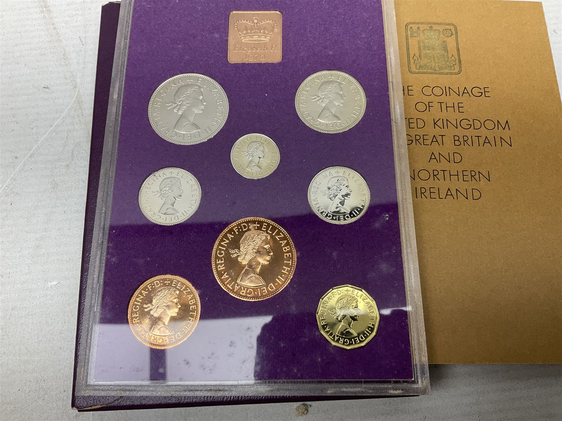 Coins and sets, including Great Britain and Northern Ireland 1970 proof coin collection in card folder, Queen Elizabeth II 2021 'Through the Looking Glass' five pounds, 2021 'Winnie the Pooh' fifty pence, Queen Victoria 1887 halfcrown, King George V 1914 halfcrown, commemorative coins, The Royal Mint Solomon Islands 2003 twenty-five dollars silver proof coin cased with certificate, 9ct gold half sovereign mount etc
