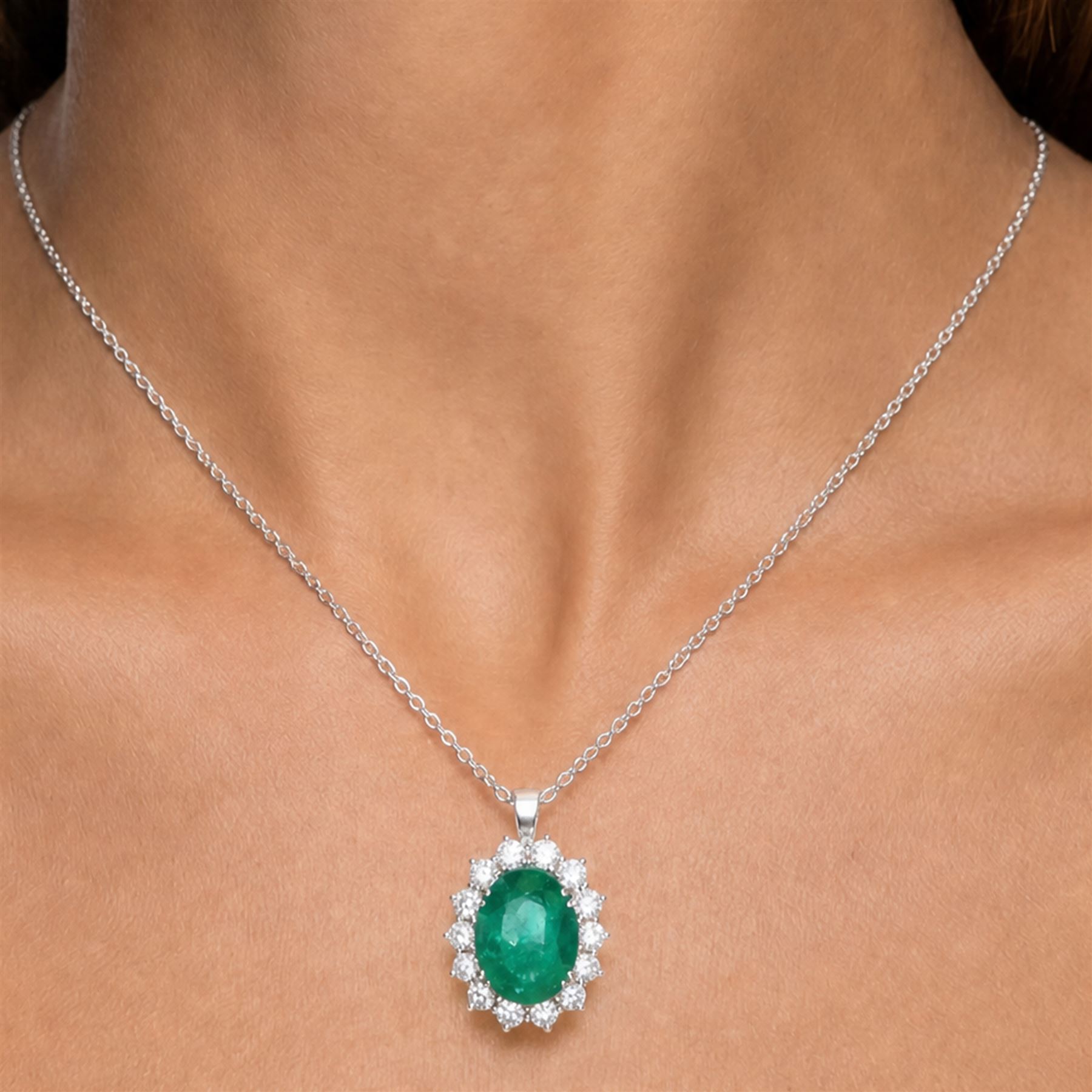 18ct white gold emerald and diamond cluster pendant necklace, single oval cut emerald of approx 4.00 carat, surrounded by fourteen round brilliant cut diamonds, hallmarked, total diamond weight approx 0.85 carat