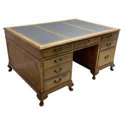 Early 20th century mahogany twin pedestal desk, the moulded rectangular top with three sectional leather insets with gilt decoration, fitted with eight drawers, on cabriole feet
