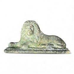 Two large cast stone figures with small lion and face stone pieces