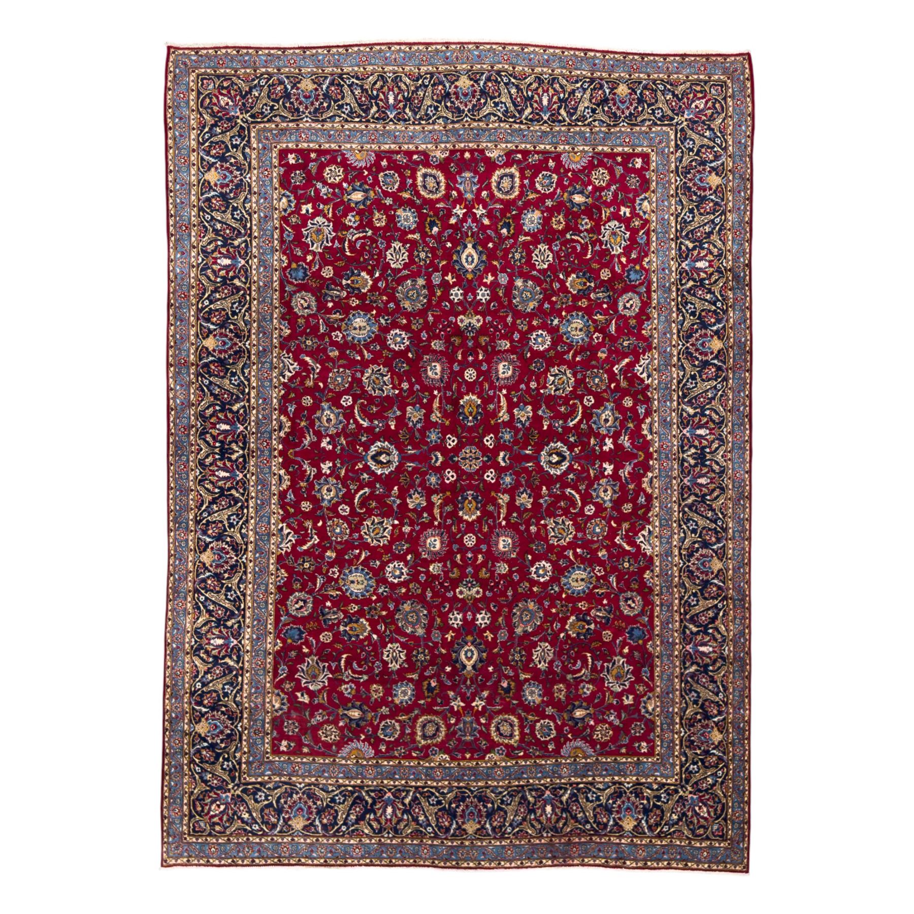 Northeastern Persian Meshed hand-knotted carpet, madder red field with an all-over design of scrolling vines, palmettes, and rosettes, within a dark blue border of palmettes and arabesques 