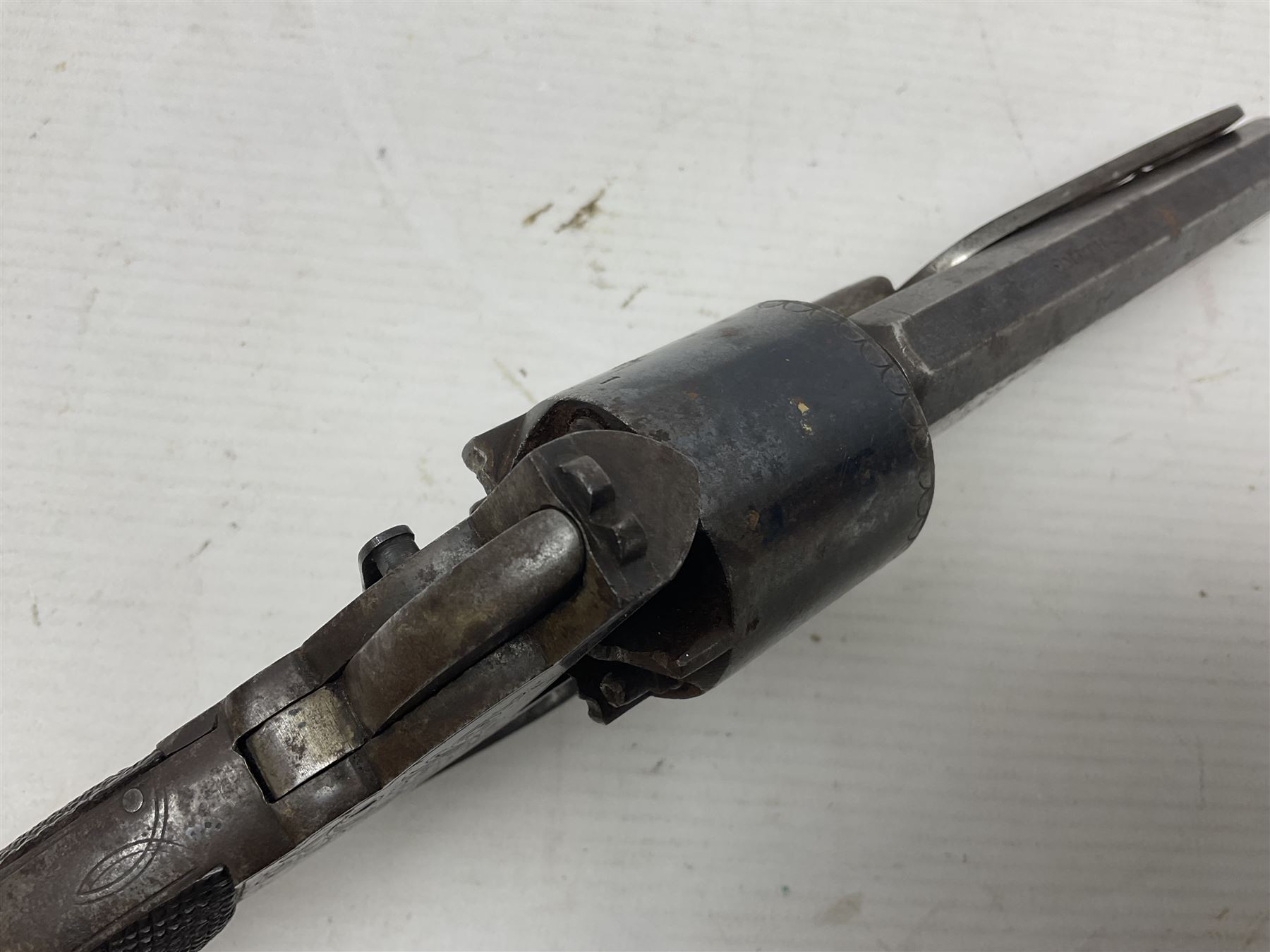 Mid-19th century Smith London .36 cal. transitional five-shot percussion revolver, the 12cm rifled octagonal barrel with side loading lever, side safety, some engraved decoration and chequered two-piece grip L28cm overall
