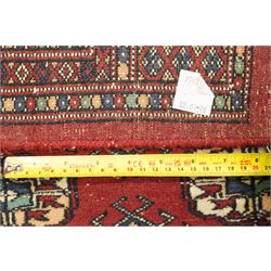 Two hand-knotted rugs, comprising Turkoman Ersari rug and Bokhara rug, Turkoman Ersari hand-knotted rug, terracotta ground with two rows of repeating octagonal guls interspersed with geometric motifs, enclosed by multiple geometric borders, fringed ends, H125cm, W93cm; Bokhara hand-knotted rug, madder red ground with three rows of repeating Tekke guls interspersed with geometric motifs, enclosed by multiple stylised floral and geometric borders, fringed ends, H188cm, W126cm