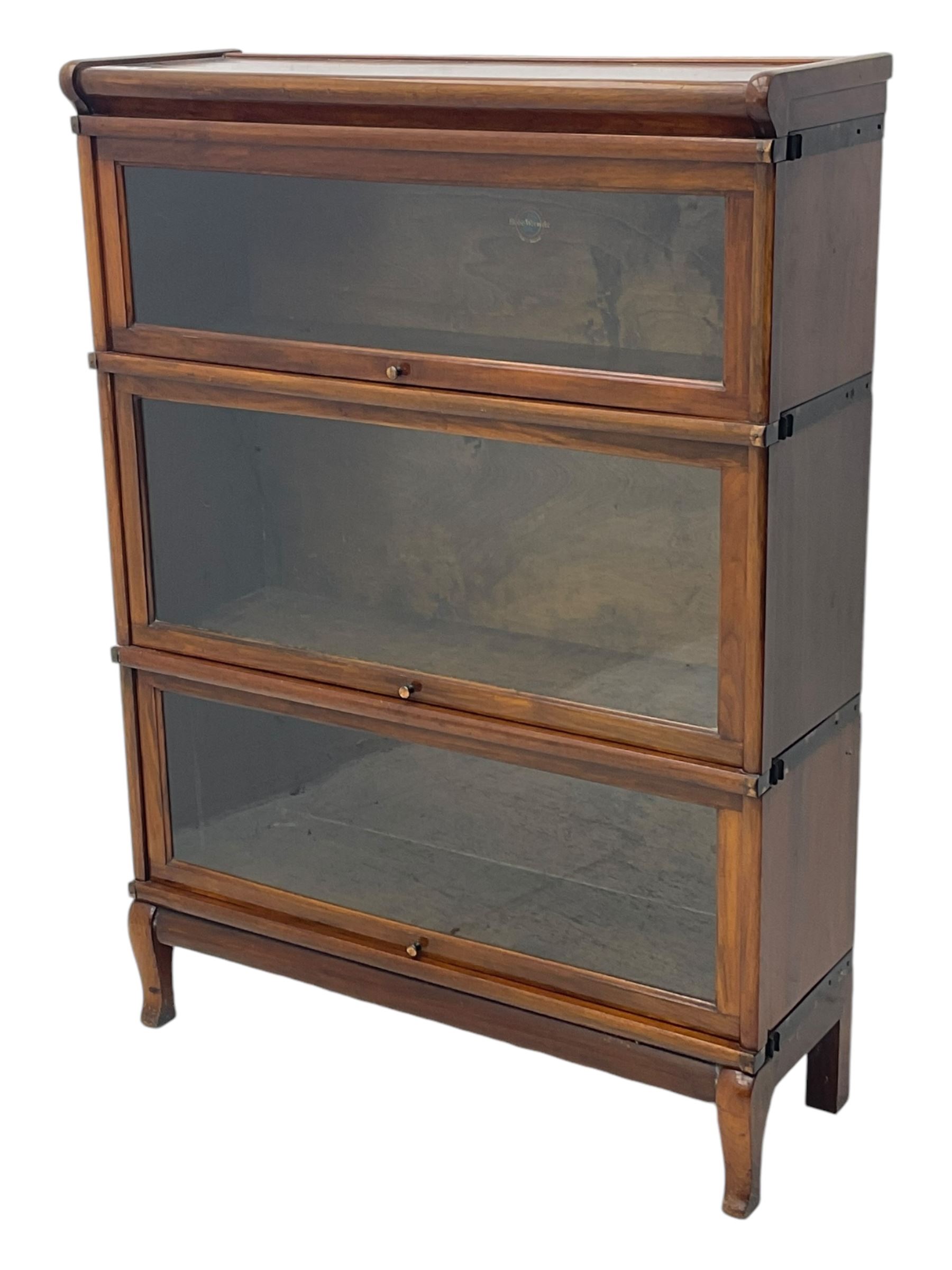 Globe Wernicke - early 20th century mahogany three-tier stacking library bookcase, three glazed sections enclosed by hinged and sliding doors, interior with transfer label, raised on cabriole front supports
