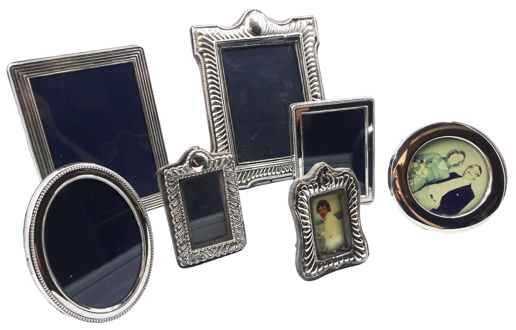 Seven modern silver mounted photograph frames, of various size and form, comprising shaped