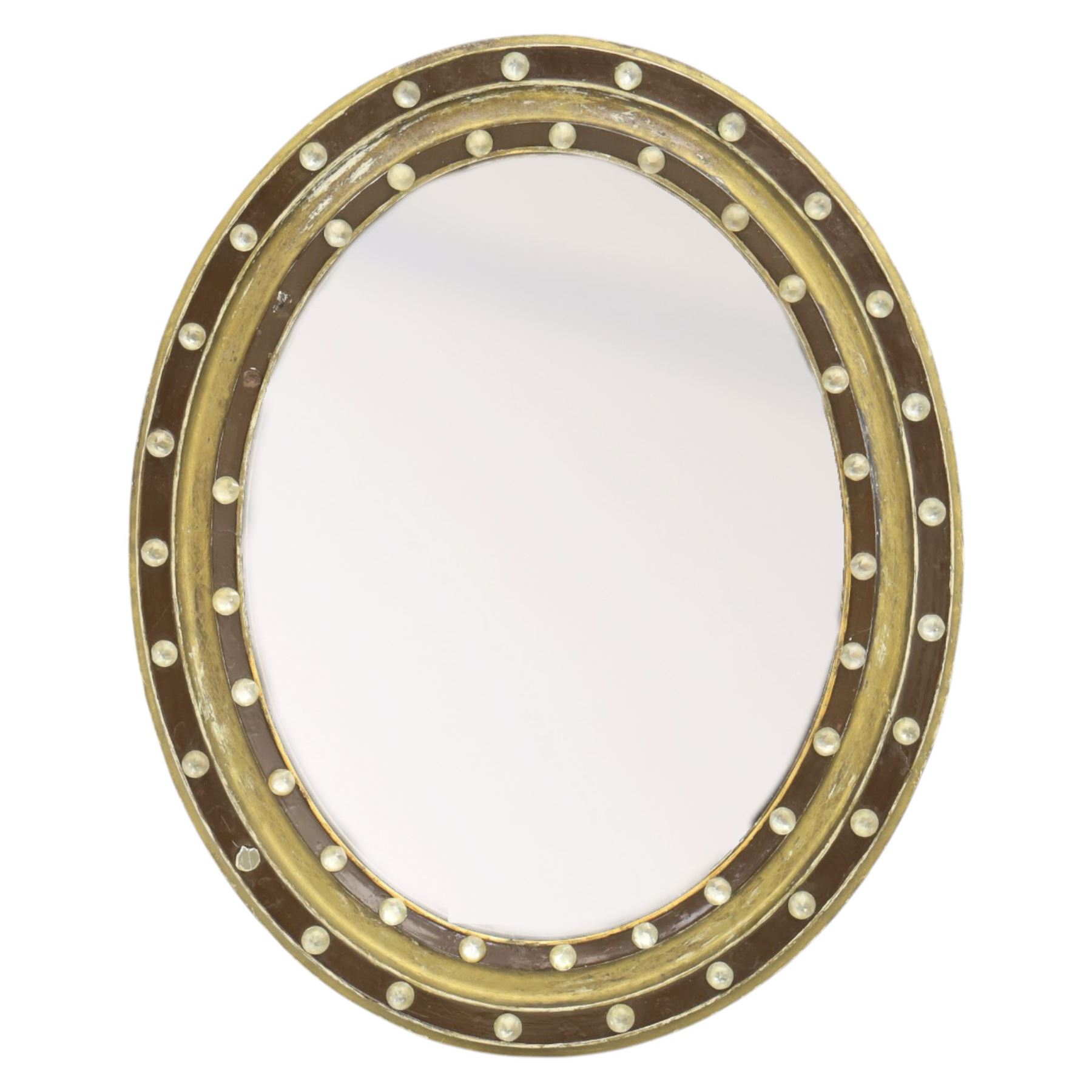 Regency design Irish oval wall mirror, circular frame with ebonized slip and two rows of applied glass ball decoration 