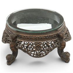 19th century Burmese carved hardwood jardinière stand, circular glazed top over pierced an...