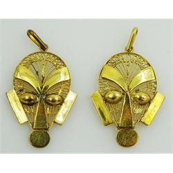 Two gold mask head pendants stamped 18K approx 4.7gm  