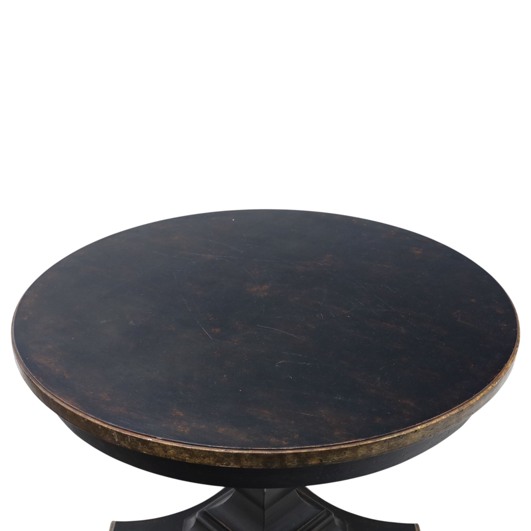 Contemporary circular painted dining table and four red upholstered chairs, table with distressed finish in black with quatriform base and bronze painted edges, chairs with 