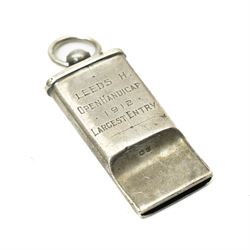 Early 20th century silver whistle inscribed 'Leeds H, Open Handicap, 1912, Largest Entry', J Hudson & Co, Birmingham 1911, Gebr. Hartmann brass folding magnifying glass, in leather case and one other