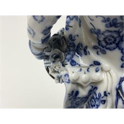Meissen blue and white figure, modelled as a gentleman holding a hat of flowers, raised upon Greek key design base, with blue crossed swords and impressed C 73 and 149 marks beneath, H18cm