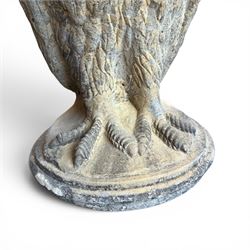 Pair of large composite stone garden statues modelled as standing horned owls, raised on circular bases