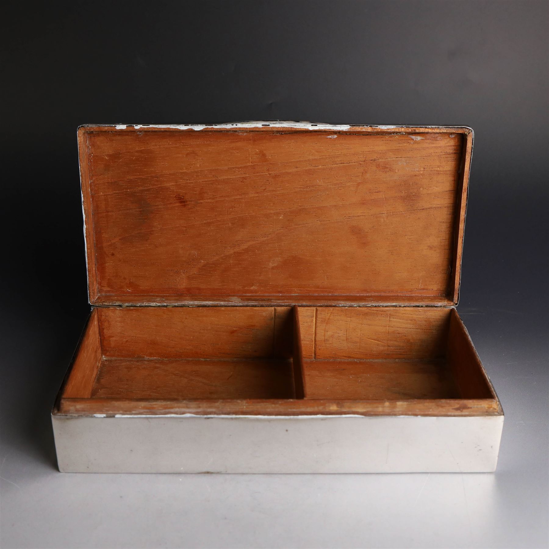 Two silver cigarette boxes, comprising early 20th century plain rectangular example with compartmentalised softwood interior, hallmarked Birmingham 1914, maker's mark indistinct, and an early 20th century example with engine turned decoration and engraved initials to cover, hallmarks worn and indistinct, largest H4.5cm, W21cm