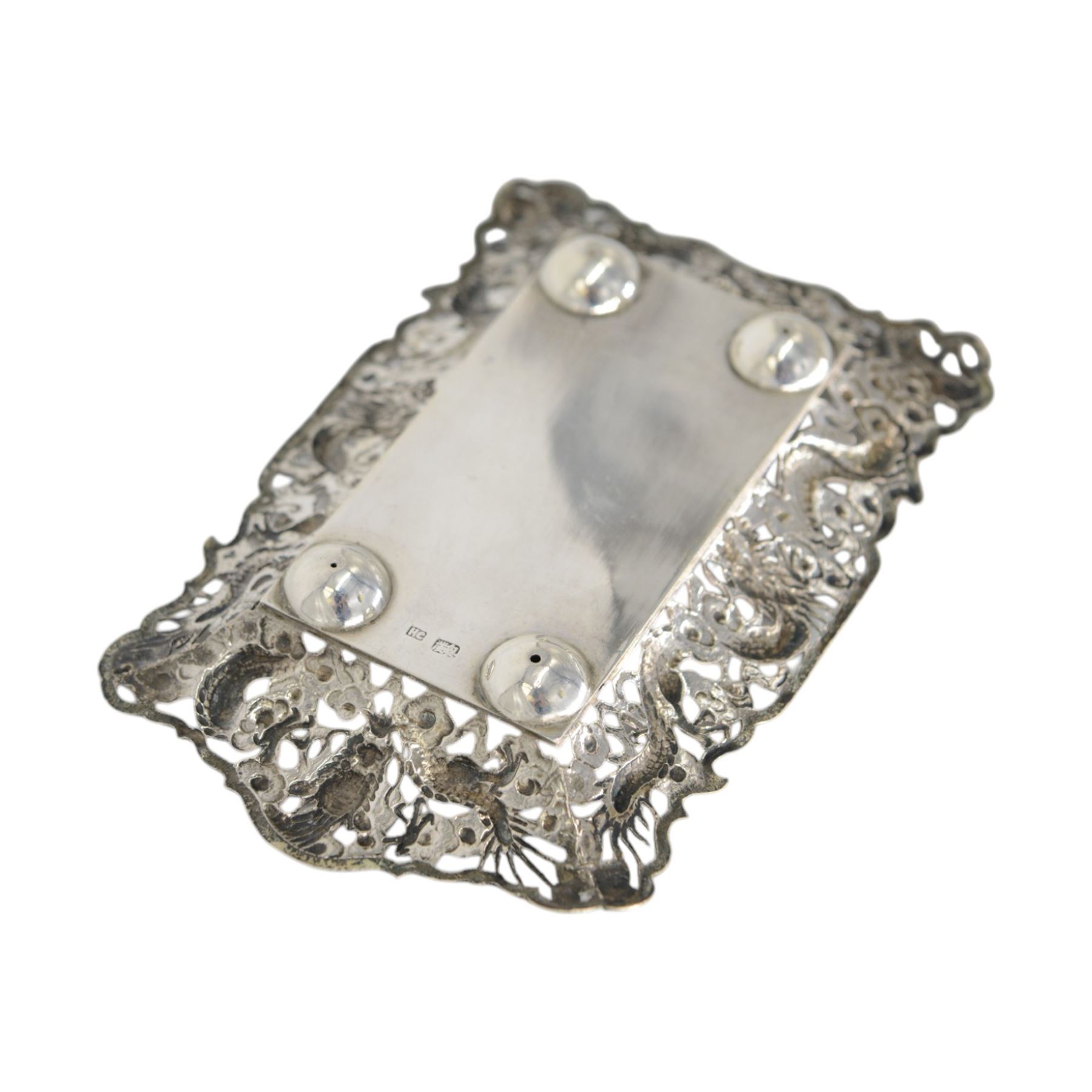 Chinese export pin tray, of rectangular form, the pierced sides embossed with dragons amongst flowers, stamped with character marks and maker's mark for Hungchong & Co, L13cm 