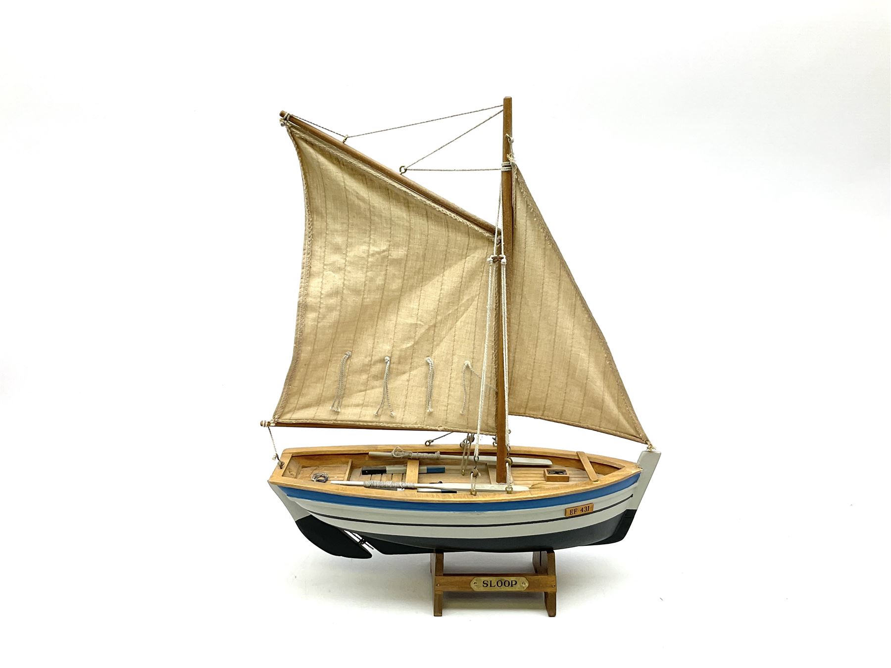 Wooden model of RMS Titanic, on a fixed black stand bearing plaque inscribed 'Titanic 1912', L54cm, H22cm, together with model of a sloop, gaff rigged on stand bearing plaque inscribed 'Sloop' L32cm, H42cm; and model of a fishing trawler on a stand bearing plaque inscribed 'Chalutier' L35cm, H28cm (3)